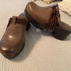 Brown leather clogs.